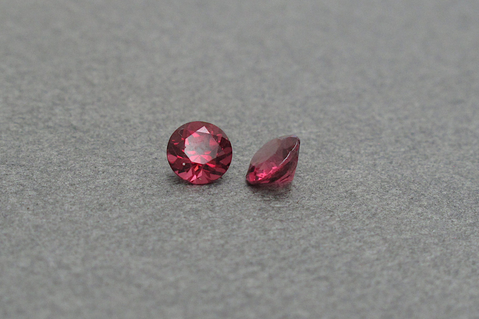 two Garnet gemstones in natural light