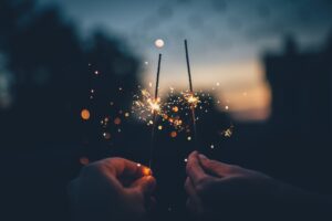 hands holding sparkle sticks
